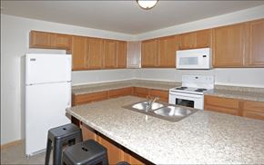 Stanley apartment for rent - a kitchen with white appliances and a granite counter top