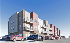 Stanley apartment for rent - a row of apartment buildings with cars parked in a parking lot