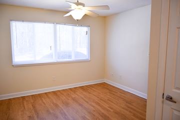 Dublin apartment for rent - an empty bedroom with a large window and a ceiling fan