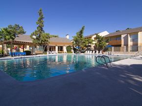 El Paso apartment for rent - Pool, lounge chairs, apt building  El Paso, Texas Apartments For Rent l Ridgemar Apartments