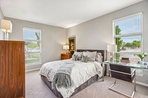 Auburn Hills apartment for rent - A bedroom with a bed, desk, and chair.
