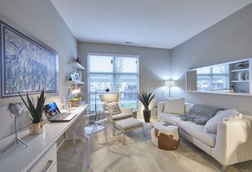 Auburn Hills apartment for rent - a living room with a couch and a desk with a laptop