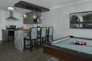 Rochester Hills townhouse for rent - Community lounge at River Oaks at Rochester Hills Apartments with pool table, bar seating, and kitchenette.