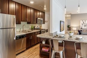 Vienna apartment for rent - Kitchen with stainless steel appliances, granite breakfast bar and pendant lights at Merrifield apartments in Vienna, VA.