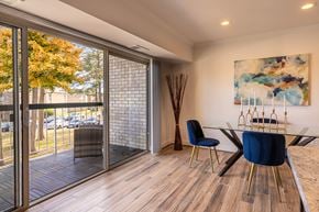Vienna apartment for rent - Dining area with glass table and blue chairs opening to balcony at Merrifield at Dunn Loring Station, Vienna, VA. Open Floor Plan