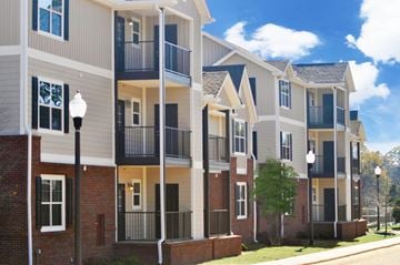 Montgomery apartment for rent - a row of townhomes with brick and siding and balconies