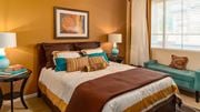 Peoria apartment for rent - a bedroom with a bed and a chair in front of a window