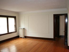 Rockford apartment for rent - an empty living room with a white wall and wood floors