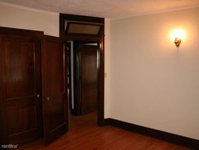 Rockford apartment for rent - an empty room with wooden doors and a light on the wall