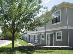 El Paso townhouse for rent - a building with a sidewalk and trees in front of it