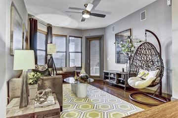 Houston apartment for rent - a living room with a chair and a ceiling fan