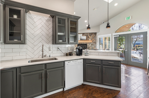Tumwater apartment for rent - a kitchen with gray cabinets and white countertops and a window