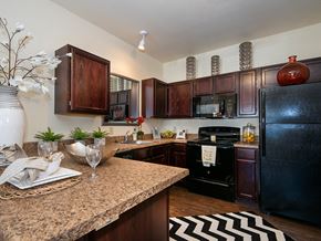Manhattan apartment for rent - a kitchen with black appliances and a granite counter top
