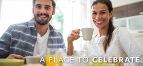 Zachary apartment for rent - a place to celebrate with a man and woman sitting at a table with a cup