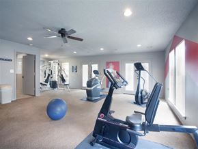 Benton apartment for rent - a gym with exercise equipment and a ceiling fan