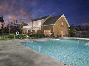 Little Rock apartment for rent - the pool at night with a house in the background