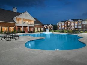 North Little Rock apartment for rent - a large swimming pool with an apartment building in the background