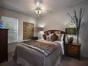 Sherwood apartment for rent - a bedroom with a bed and a ceiling fan