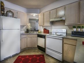 Sherwood apartment for rent - a kitchen with white appliances and a red rug