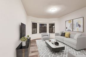 San Francisco apartment for rent - A living room with a grey couch, a black coffee table, and a TV on the wall.