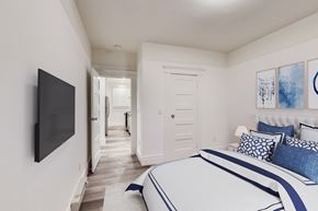 San Francisco apartment for rent - A bedroom with a large bed and a flat screen TV mounted on the wall.