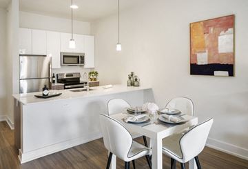Jersey City apartment for rent - A modern kitchen with a dining table set for two.