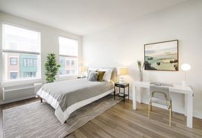 Jersey City apartment for rent - A bedroom with a large bed and a desk with a chair.