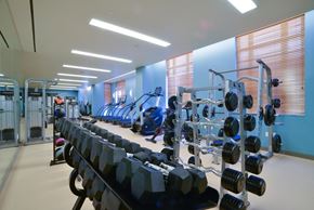 Washington apartment for rent - A gym with a variety of equipment including dumbbells and weight machines.