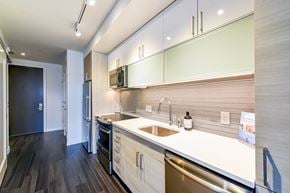 Washington apartment for rent - A modern kitchen with a white countertop and stainless steel appliances.