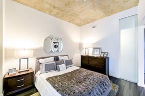 Washington apartment for rent - A bedroom with a bed, nightstand, and lamp.