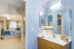 Fountain Valley apartment for rent - a bathroom with a sink and a mirror and a bedroom