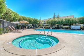 Redding apartment for rent - a swimming pool with a hot tub and a resort style fenced in area