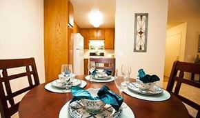 Buena Park apartment for rent - a dining room table with plates on it