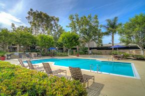 Buena Park apartment for rent - a swimming pool with chars and umbrellas at the resort