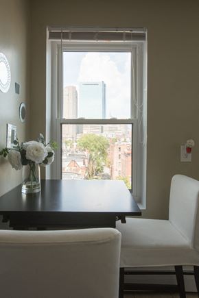 Boston apartment for rent - a dining room table with a view of a window