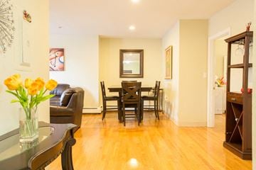 Boston apartment for rent - a living room and dining room with a table and chairs