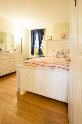 Boston apartment for rent - a bedroom with a bed and a dresser and a window