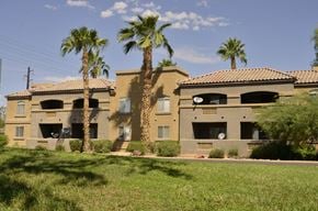 Scottsdale apartment for rent - a building with palm trees in front of it
