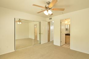 Scottsdale apartment for rent - a bedroom with a ceiling fan and a mirror