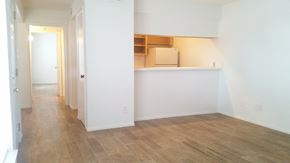 Conroe apartment for rent - an empty living room with white walls and a wood floor