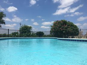 Conroe apartment for rent - a large swimming pool with a blue sky in the background