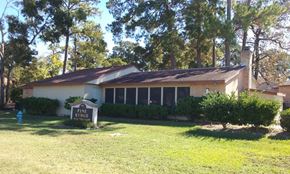Conroe apartment for rent - a house with a yard and a sign in front of it