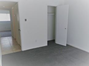 Houston apartment for rent - an empty living room with white walls and doors