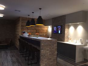 Morristown apartment for rent - a bar with stools and a television on the wall