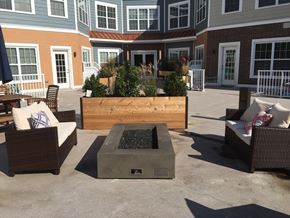 Morristown apartment for rent - a firepit in the center of a patio with chairs and tables