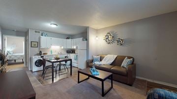 Greenville apartment for rent - a living room and kitchen with a couch and a table