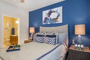 Sandy Springs apartment for rent - A bedroom with a large bed and a painting on the wall.
