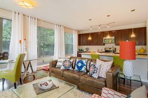 Sandy Springs apartment for rent - A living room with a couch, chairs, and a glass table.
