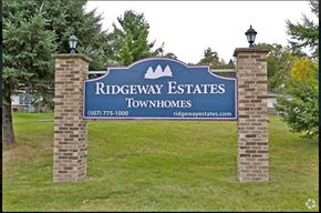 Pine Island townhouse for rent - a sign for ridgeway estates townhomes in the grass