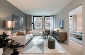 New York apartment for rent - a living room with a couch and a table and a window